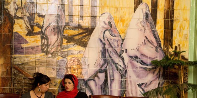 MASCARA, ALGERIA - APRIL 16: April 16th, 2011, Algeria. Inside Mascara's cultural center, two young women are waiting for Yasmina Khadra who is to give a lecture. When he arrived, the writer was welcomed by an enthusiastic and passionate crowd. (Photo by Reza/Getty Images)