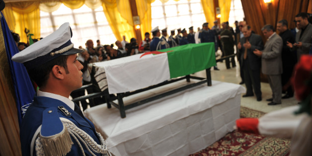 Algerian policeman stands guard as relatives pay respects to the flag-draped coffin of Algeria's police chief Ali Tounsi at a ceremony to pay the last tribute at the police training academy, on February 26, 2010 in Algiers. Tounsi was shot dead Thursday during a blazing row with a subordinate in his office at police headquarters in central Algiers. AFP PHOTO / FAYEZ NURELDINE (Photo credit should read FAYEZ NURELDINE/AFP/Getty Images)