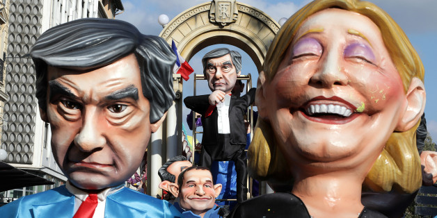 Fugures of Francois Fillon (L), former French prime minister, member of The Republicans political party and 2017 presidential candidate of the French centre-right, French National Front leader Marine Le Pen (R) and French Socialist party 2017 presidential candidate Benoit Hamon (bottom C) are paraded through the crowd during the Carnival parade of the 133rd carnival, the first major event since the city was attacked during Bastille Day celebrations last year in Nice, France, February 19, 2017.