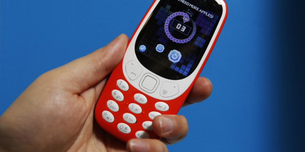 An attendee holds the new Nokia 3310 mobile phone, developed by HMD Global OY, in warm red, during a product launch event in London, U.K., on Friday, Feb. 24, 2017. Licensee HMD Global says more Nokia-branded models to launch in first half of 2017. Photographer: Luke MacGregor/Bloomberg via Getty Images