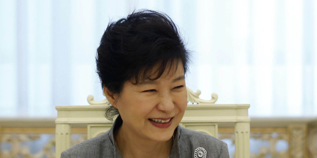 South Korean President Park Geun-hye smiles as she listen to a reporter's question during an interview with Reuters at the Presidential Blue House in Seoul September 16, 2014. Park, thwarted so far in ambitious plans to begin the process of reunifying the Korean peninsula, said the door is open for talks with the North during the upcoming U.N. General Assembly. However, Park said in the interview that Pyongyang must show sincerity in seeking a constructive dialog and "walk the talk" in taking up South Korea's offers for engagement aimed at ending a deadlock after a decade of warming ties. Picture taken on September 16. To match Exclusive SOUTHKOREA-PRESIDENT/INTERVIEW REUTERS/Kim Hong-Ji (SOUTH KOREA - Tags: POLITICS)