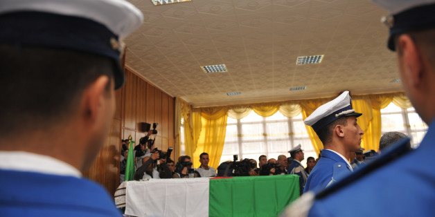 Algerian policemen pay respects to the flag-draped coffin of Algeria's police chief Ali Tounsi at a ceremony to pay the last tribute at the police training academy, on February 26, 2010 in Algiers. Tounsi was shot dead Thursday during a blazing row with a subordinate in his office at police headquarters in central Algiers. AFP PHOTO / FAYEZ NURELDINE (Photo credit should read FAYEZ NURELDINE/AFP/Getty Images)