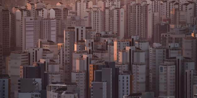 A general view shows apartment buildings and the city skyline at sunrise in Seoul on December 10, 2016.A day after South Korean lawmakers successfully impeached scandal-hit President Park Geun-Hye, hundreds of thousands of people were expected to take to the streets of Seoul for a scheduled protest turned celebration. / AFP / Ed JONES (Photo credit should read ED JONES/AFP/Getty Images)