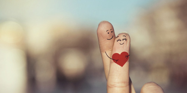Happy loving fingers holding red heart