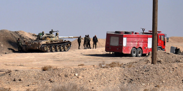 Syrian regime forces gather in a position as they advance towards Hayyan oil field, east of the central Syrian Homs province on February 7, 2017.
Regime troops had captured the Hayyan oilfield west of the celebrated desert city of Palmyra. / AFP / STRINGER (Photo credit should read STRINGER/AFP/Getty Images)