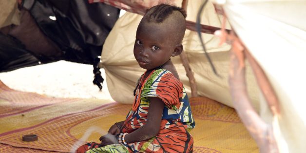TO GO WITH AFP STORY BY PATRICK FORT
A child looks on under a makeshift tent in a camp in the village of Kidjendi near Diffa on June 19, 2016 as displaced families fled from Boko Haram attacks in Bosso.
Earlier this month 24 soldiers from Niger and two Nigerian troops were killed in a Boko Haram attack in the Bosso area of Niger, near Lake Chad, prompting Chad to send in reinforcements.
/ AFP / ISSOUF SANOGO (Photo credit should read ISSOUF SANOGO/AFP/Getty Images)