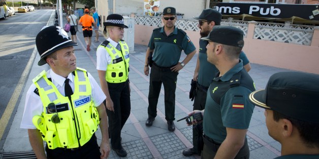 British police officers, popularly known as 'bobbies' walk Spanish Civil Guards as they patrol at Punta Ballena street in the holiday resort of Magaluf in Calvia on Mallorca Island on August 11, 2015.Two 'bobbies', a man and a woman who speak Spanish, patrolled today morning with the Spanish Guardia Civil in Magaluf, a Majorca beach in the Spanish Balearic archipelago, where the British holidaymakers' alcohol and sex excesses are scandalous. AFP PHOTO / JAIME REINA (Photo credit should
