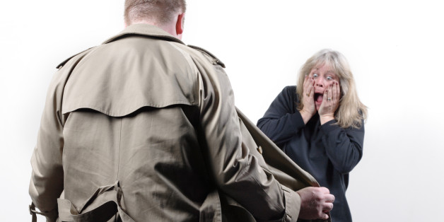 Sketchy guy shows off the goods to a horrified woman. Seriously, this guy is bad news.