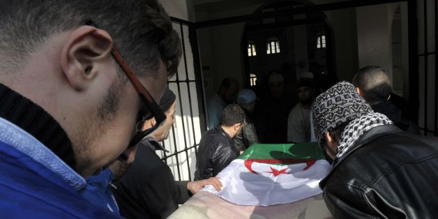 Relatives and friends carry the body of British-Algerian journalist Mohamed Tamalt during his funeral, on December 12, 2016 in Algiers.Mohamed Tamalt died on December 11, 2016 after having staged a hunger strike to protest a two-year jail term for offending Algeria's president in a poem posted online, his lawyer said. / AFP / RYAD KRAMDI (Photo credit should read RYAD KRAMDI/AFP/Getty Images)