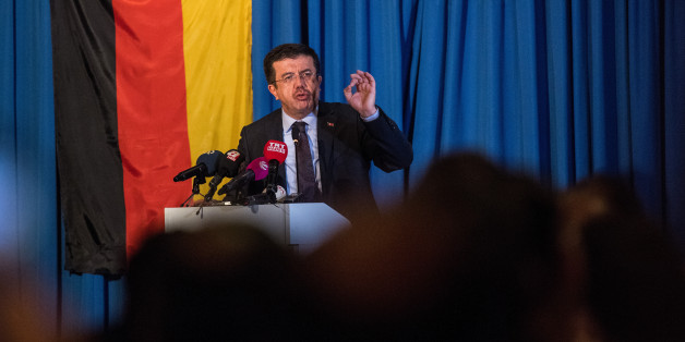 COLOGNE, GERMANY - MARCH 05: Turkish Economy Minister Nihat Zeybekci talks to Turks attend an event organized by the Turkish AKP, the political party of Turkish President Recep Tayyip Erdogan, on March 5, 2017 in Cologne, Germany. Zeybekci had sought to speak at a rally in Cologne in support of a 'yes' vote in the upcoming referendum in Turkey, though local authorities intervened and blocked the initial venue. Turkish government officials, at the invitation of an organization called the Union of