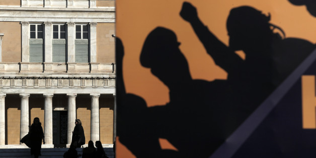The Greek Parliament is seen behind a banner set by police officers at Syntagma square, during an anti-austerity rally, in central Athens, Greece, on February 22, 2017. Police officers,firefighters and coast guard officers demonstrate against new austerity measures and spending cuts promoted by the government. (Photo by Panayotis Tzamaros/NurPhoto via Getty Images)