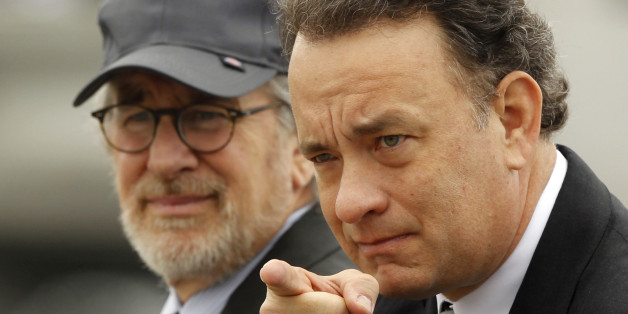 Executive Producers of the mini series "The Pacific", director Steven Spielberg (L) and actor Tom Hanks participate in a tribute to veterans at the World War II Memorial on the Washington Mall, March 11, 2010. The pair were joined by 250 World War II veterans in a tribute to those who served in the Pacific theater of World War II, before the March 14 premiere of the 10-part HBO miniseries "The Pacific". REUTERS/Jason Reed (UNITED STATES - Tags: ENTERTAINMENT IMAGES OF THE DAY)
