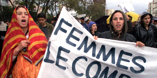 Algerian women hold a banner reading "Women, the Fight", as they march in Algiers to demand the repeal of the Algerian family laws (code de la famille) March 7, 2002. The demonstration was organised on the eve of International Women's Day.