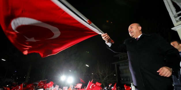 HAMBURG, GERMANY - MARCH 7: (----EDITORIAL USE ONLY MANDATORY CREDIT - TURKISH FOREIGN MINISTRY - AHMET GUMUS - HANDOUT' - NO MARKETING NO ADVERTISING CAMPAIGNS - DISTRIBUTED AS A SERVICE TO CLIENTS----) Turkish Foreign Minister Mevlut Cavusoglu (R) meets with Turkish people living in Europe at residence of Turkish Consulate-General in Hamburg on March 7, 2017, in Hamburg, Germany. (Photo by Turkish Foreign Ministry / Ahmet Gumus / Handout/Anadolu Agency/Getty Images)