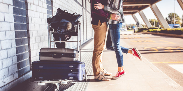 Young couple kissing outside airport
