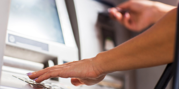 Close up of unrecognizable female person withdrawing money from ATM.