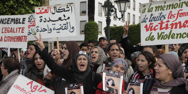 Women from various regions of Morocco hold placards as they protest against violence towards women, in Rabat November 24, 2013. The placard reads, "In memory of all women victims of violence". REUTERS/Youssef Boudlal (MOROCCO - Tags: CIVIL UNREST SOCIETY POLITICS)