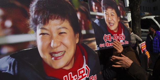Pro-government activists hold a portraits of South Korean President Park Geun-Hye outside the Constitutional Court in Seoul on February 27, 2017 as the court holds its final hearing in the impeachment trial of Park Geun-Hye. / AFP / JUNG Yeon-Je (Photo credit should read JUNG YEON-JE/AFP/Getty Images)