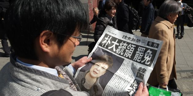 A man reads an extra edition of a Japanese major newspaper reporting on South Korean President Park Geun-hye's impeachment in Tokyo on March 10, 2017.
South Korean President Park Geun-Hye was fired by the country's top court on March 10, as it upheld her impeachment by parliament over a wide-ranging corruption scandal. / AFP PHOTO / Kazuhiro NOGI (Photo credit should read KAZUHIRO NOGI/AFP/Getty Images)