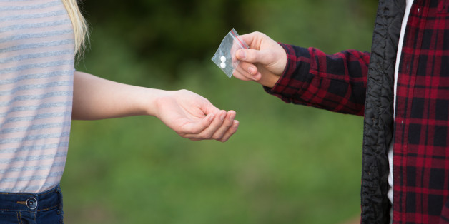 Teenage Girl Buying Drugs In Playground From Dealer