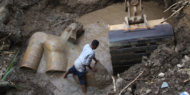 CAIRO, March 9, 2017: An Egyptian worker prepares to lift parts of a statue at the site of a new archeological discovery at Souq Al-Khamis district in Al-Matareya area, Cairo, Egypt on March 9, 2017. According to the Ministry of Antiquities, two 19th dynasty royal statues were found in parts in the vicinity of King Ramses II temple in ancient Heliopolis (Oun) Sun Temples by a German-Egyptian archeological mission. (Xinhua/Ahmed Gomaa via Getty Images)