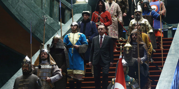 Turkey's President Tayyip Erdogan walks down the stairs in between soldiers, wearing traditional army uniforms from the Ottoman Empire, as he arrives for a welcoming ceremony for Palestinian President Mahmoud Abbas (not pictured) at the Presidential Palace in Ankara January 12, 2015. REUTERS/Adem Altan/Pool (TURKEY - Tags: POLITICS)