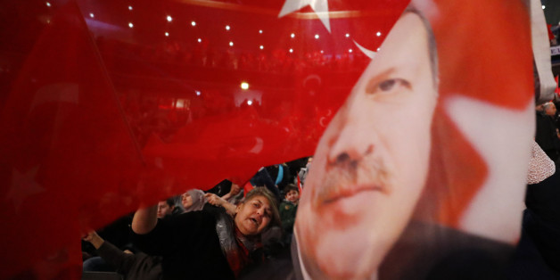 People wave with flags showing Turkish President Recep Tayyip Erdogan before Turkish Prime Minister Binali Yildirim is expected to address a crowd of around 10,000 in Oberhausen, Germany, February 18, 2017, to promote Turkey's constitution referendum on April 16, 2017. REUTERS/Wolfgang Rattay TPX IMAGES OF THE DAY