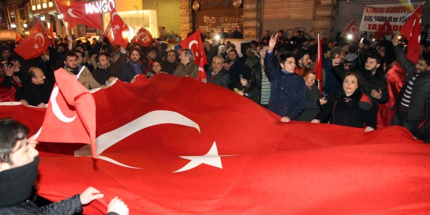 ISTANBUL, TURKEY - MARCH 12: Turkish people chant slogans and hold Turkish flags to protest Netherlands in front of Dutch Diplomatic Mission in Istanbul as it was sealed off due to security concerns in Istanbul, Turkey on March 12, 2017. Turkish family minister Fatma Betul Sayan Kaya's vehicle intercepted by Dutch police while entering the Consulate General's residence of Turkey in Rotterdam.
(Photo by Abdullah Coskun/Anadolu Agency/Getty Images)