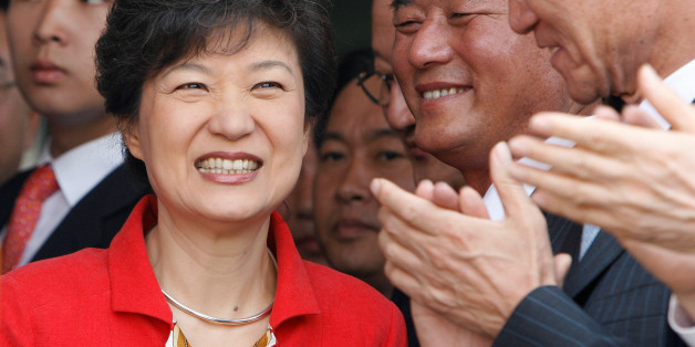FILE PHOTO: Lawmakers and supporters of Park Geun-hye (L) clap their hands at the main office of the main opposition Grand National Party (GNP) in Seoul June 11, 2007. REUTERS/Lee Jae-Won/File Photo