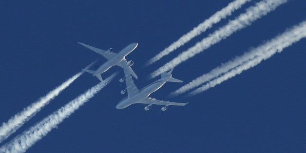 Two airliners pass in the sky above Malta as the drama of a hijacked Libyan Afriqiyah Airways Airbus A320 is played out on the runway beneath at Malta Airport, December 23, 2016. REUTERS/Darrin Zammit-Lupi MALTA OUT
