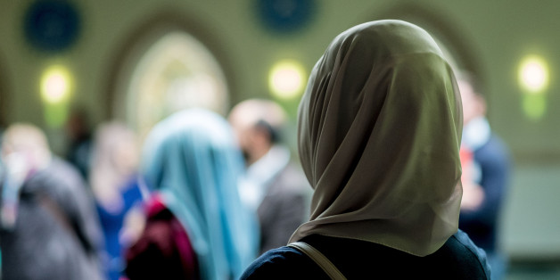 Muslim women stand in the Aya Sofya mosque on October 3rd, 2016 in Hanover, northern Germany, as visitors attend the Open-Mosque-Day. Every year on October 3rd, the Day of German Unity, hundreds of mosques invite visitors accross the country on the Day of the Open Mosque. / AFP / dpa / Peter Steffen / Germany OUT (Photo credit should read PETER STEFFEN/AFP/Getty Images)