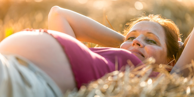 Outdoor natural portrait of beautiful pregnant woman