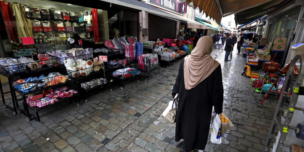 A woman walks in a street in the suburb of Molenbeek, after security was tightened in Belgium following the fatal attacks in Paris on Friday, in Brussels, Belgium, November 17, 2015. REUTERS/Yves Herman