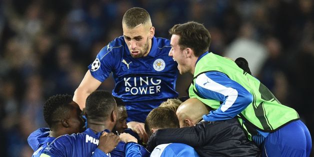 Leicester City's Algerian striker Islam Slimani (CL top) jumps in to celebrate with his Leicester teammates after their victory at the end of the UEFA Champions League round of 16 second leg football match between Leicester City and Sevilla at the King Power Stadium on March 14, 2017. / AFP PHOTO / Oli SCARFF (Photo credit should read OLI SCARFF/AFP/Getty Images)