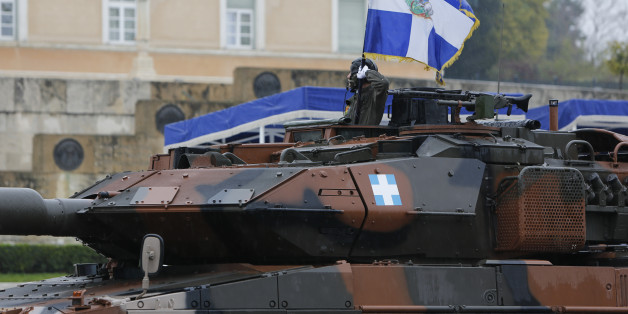 SYNTAGMA SQUARE, ATHENS, ATTICA, GREECE - 2015/03/25: A soldier in a German Leopard 2 Main Battle Tank holds an Army regimental war flag during the military parade in Athens. A military parade was held in Athens despite heavy rain, to celebrate the 194th Greek Independence Day. The day celebrates the start of the Greek War of Independence in 1821, which lead to the independence of Greece from the Ottoman Empire. (Photo by Michael Debets/Pacific Press/LightRocket via Getty Images)