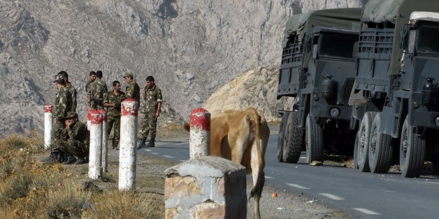 Algerian troops rest as they conduct a search operation near the village of Ait Ouabane, 80 kilometres south of Tizi Ouza, for the body of 55-year old French tourist and moutain-guide Herve Gourdel, who was kidnapped on September 21 while hiking in Algeria's Djurdjura National Park, and beheaded three days later by a group linked to Islamic State jihadists in Iraq and Syria, Algeria is continuing to devote significant resources in Kabylia to find the body of Gourdel Herve and locate his killers,