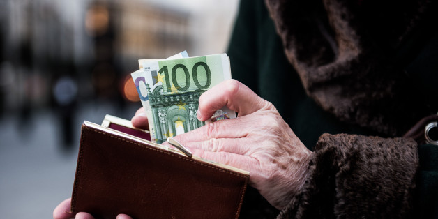 A customer places euro banknotes into a purse ahead of the 171st Organization of Petroleum Exporting Countries (OPEC) meeting in Vienna, Austria, on Tuesday, Nov. 29, 2016. An OPEC deal to curtail oil production appeared in jeopardy as Iran said it wont make cuts while Saudi Arabia insisted Tehran must be willing to play a meaningful role in any agreement. Photographer: Akos Stiller/Bloomberg via Getty Images