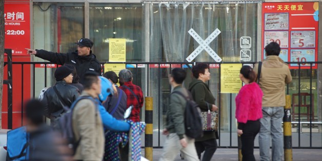 BEIJING, CHINA - MARCH 13: Citizens walk past a supermarket of South Korea's Lotte Group, which is shut down for violating fire safety rules on March 13, 2017 in Beijing, China. Lotte has faced growing opposition in China since signing a deal to provide land to host the Terminal High-Altitude Area Defense (THAAD) system. And dozens of Lotte stores have been closed in China. (Photo by VCG/VCG via Getty Images)