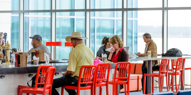 Houston, TX, USA - September 14, 2014: IAH, Houston Intercontinental Airport, Houston, TX, USA - people seated at restaurant bar in an airport
