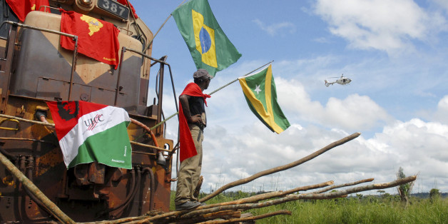A Brazilian man belonging to the Movimento dos Trabalhadores em Mineracao (Mining Workers Movement) stands on logs they placed to block the Carajas railroad line used by the Vale mining company in Parauapebas in the state of Para April 17, 2008. The miners were commemorating the anniversary of the 1996 Massacre of Eldorado dos Carajas when police fired upon a group of landless peasants who were blocking a highway to demand agrarian reform, killing 19 and injuring nearly 70. REUTERS/Paulo Santos (BRAZIL)