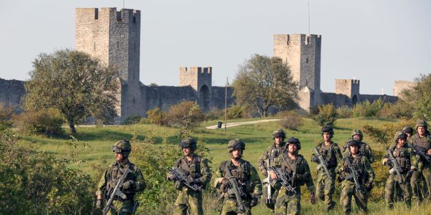 A squad from Skaraborg Armoured Regiment patrol outside Visby's 13th century city wall in Sweden on September 14, 2016.
Sweden's Baltic Sea island of Gotland is once again home to a permanent military presence, the military said, amid speculation over the country's ability to defend itself against a more assertive Russia. / AFP / TT NEWS AGENCY AND TT News Agency / SOREN ANDERSSON / Sweden OUT (Photo credit should read SOREN ANDERSSON/AFP/Getty Images)