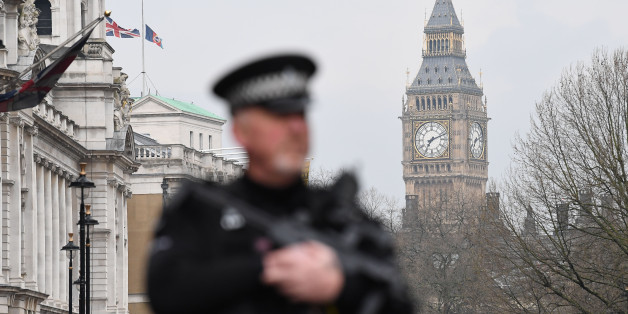 An armed police officer patrols by a security cordon set up along Whitehall by the Houses of Parliament on March 23, 2017 in London.
Seven people have been arrested including in London and Birmingham over Wednesday's terror attack at the British parliament, the police said today, revising down the number of victims to three people. / AFP PHOTO / Justin TALLIS (Photo credit should read JUSTIN TALLIS/AFP/Getty Images)