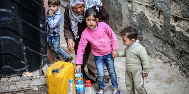 Palestinians filling bottles and jerricans with drinking water at Al-Shati refugee camp in the southern Gaza Strip, on March 22, 2017. More and more Gazans are falling ill from their drinking water, highlighting the humanitarian issues facing the Palestinian enclave that the UN says could become uninhabitable by 2020. (Photo by Hosam Salem/NurPhoto via Getty Images)