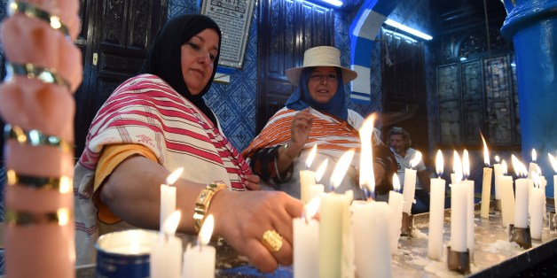 Jewish pilgrims light candles in the Ghriba synagogue on the Mediterranean resort island of Djerba on May 18, 2014. Pilgrims arrived at Tunisia's Ghriba synagogue, the oldest in Africa, expressing hope that this year would mark a turning point for the ritual despite a rise in Islamist unrest since the 2011 revolution. AFP PHOTO / FETHI BELAID (Photo credit should read FETHI BELAID/AFP/Getty Images)