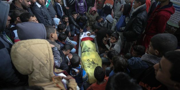 Palestinian relatives of 18-year-old Yousef Abu Azra sit around his body in Al-Awda mosque during his funeral in Rafah refugee camp in the southern Gaza Strip, 22 March 2017. According to Palestinian officials, Abu Azra was killed and two others were injured in Israeli shelling east of Rafah town near the border between Israel and Gaza Strip.