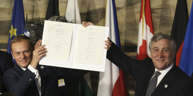 European Council President Donald Tusk (L) and European Parliament President Antonio Tajani hold up a document signed by EU leaders during their meeting on the 60th anniversary of the Treaty of Rome, in Rome, Italy March 25, 2017. REUTERS/Remo Casilli