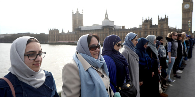 Participants in the Women's March, gather on Westminster Bridge to hold hands in silence, to remember victims of the attack in Westminster earlier in the week, in London, Britain March 26, 2017. REUTERS/Neil Hall