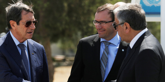 Greek Cypriot leader and Cyprus President Nicos Anastasiades (L) shake hands with Turkish Cypriot leader Mustafa Akinci (R), as UN envoy Espen Barth Eide looks on, in the buffer zone of Nicosia airport, Cyprus September 14, 2016. REUTERS/Yiannis Kourtoglou