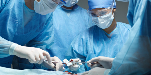 Medical team performing an operation in operating theater