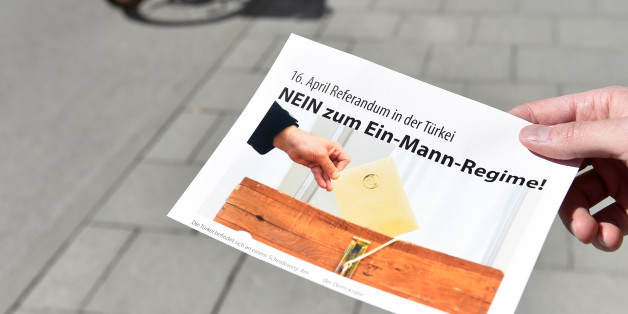 A man holds a flyer with the inscription 'April 16 - referendum in Turkey - No to the one-man regime!' in front of a polling station in the Bavarian city of Munich, southern Germany, on March 27, 2017.
Turkish expatriates in Germany and five other European countries started casting their ballots Monday in a controversial referendum that could vastly boost President Recep Tayyip Erdogan's powers. / AFP PHOTO / Christof STACHE (Photo credit should read CHRISTOF STACHE/AFP/Getty Images)